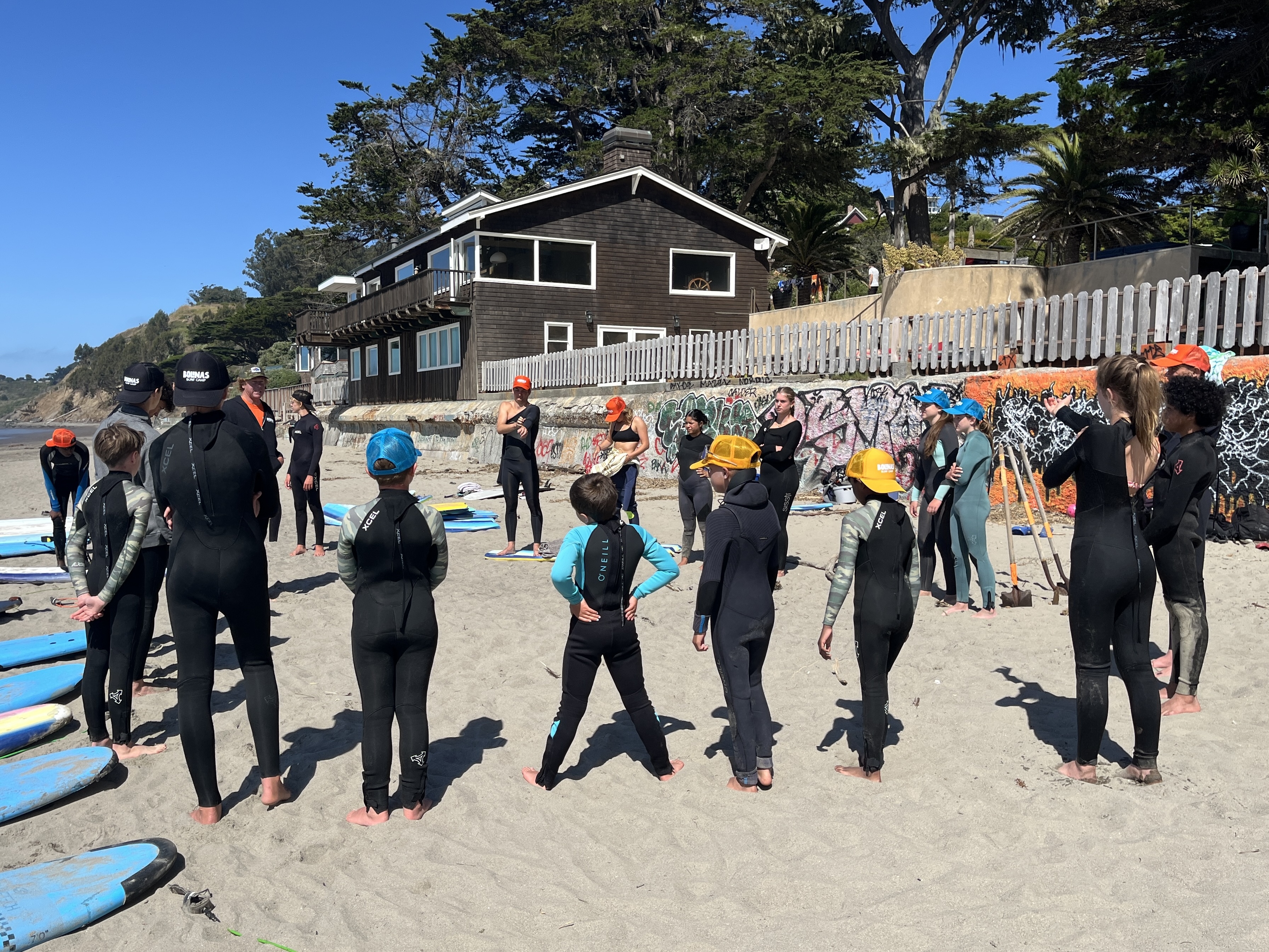 Campers gathered around to plan day of surfing. 